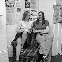 Two people, one armchair